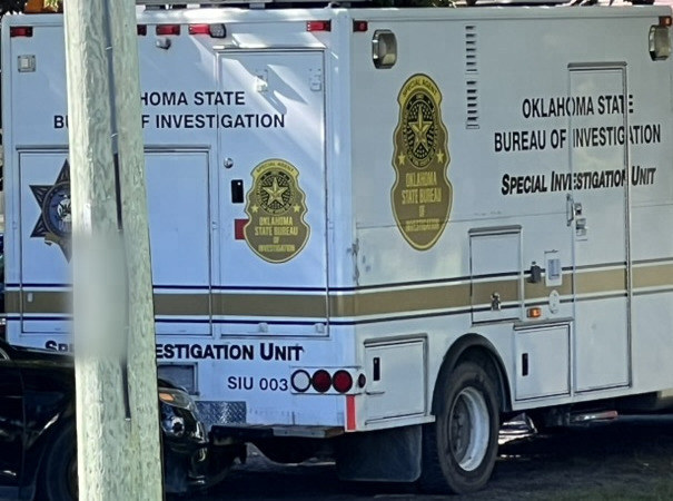 A white prop mobile command van with gold seals, lettered Oklahoma State Bureau of Investigation, Special Investigation Unit, SIU 003.