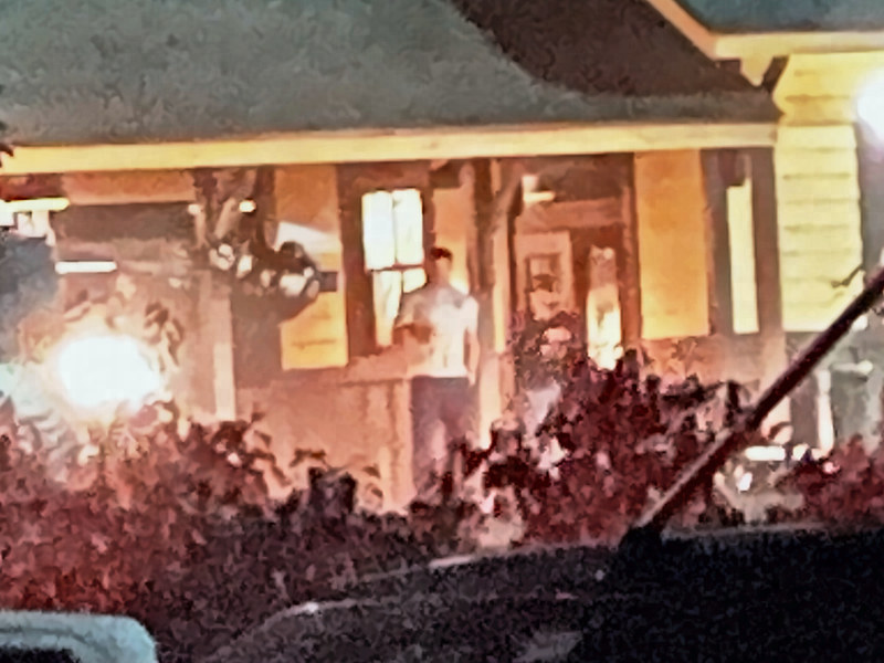 Enlarged view of the lit deck with a man in a white T-shirt and camera gear.