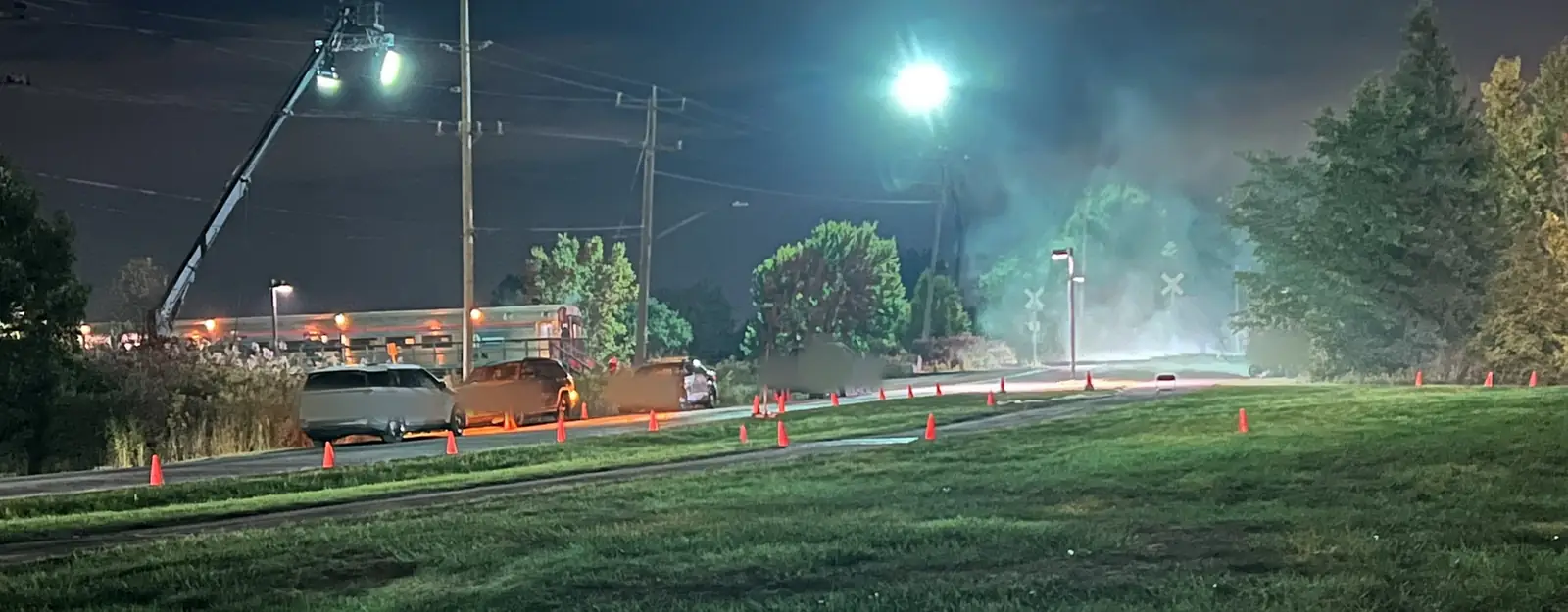Picture cars, cones and a lighting crane during a night shoot