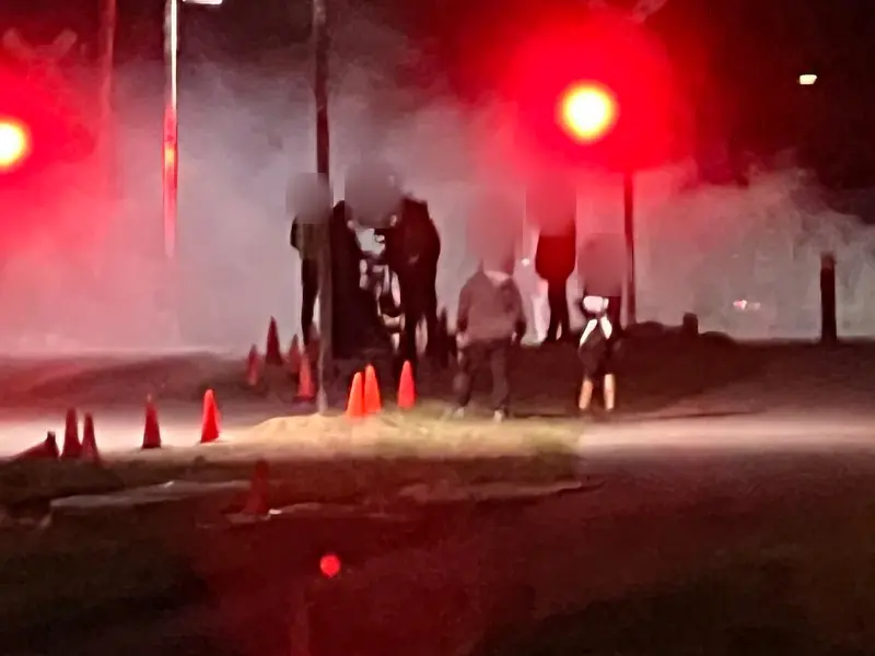 Camera crew working in stage smoke at night