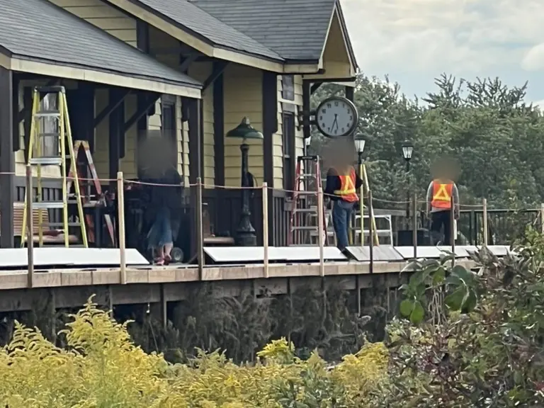 Crew in safety vests working on a set platform
